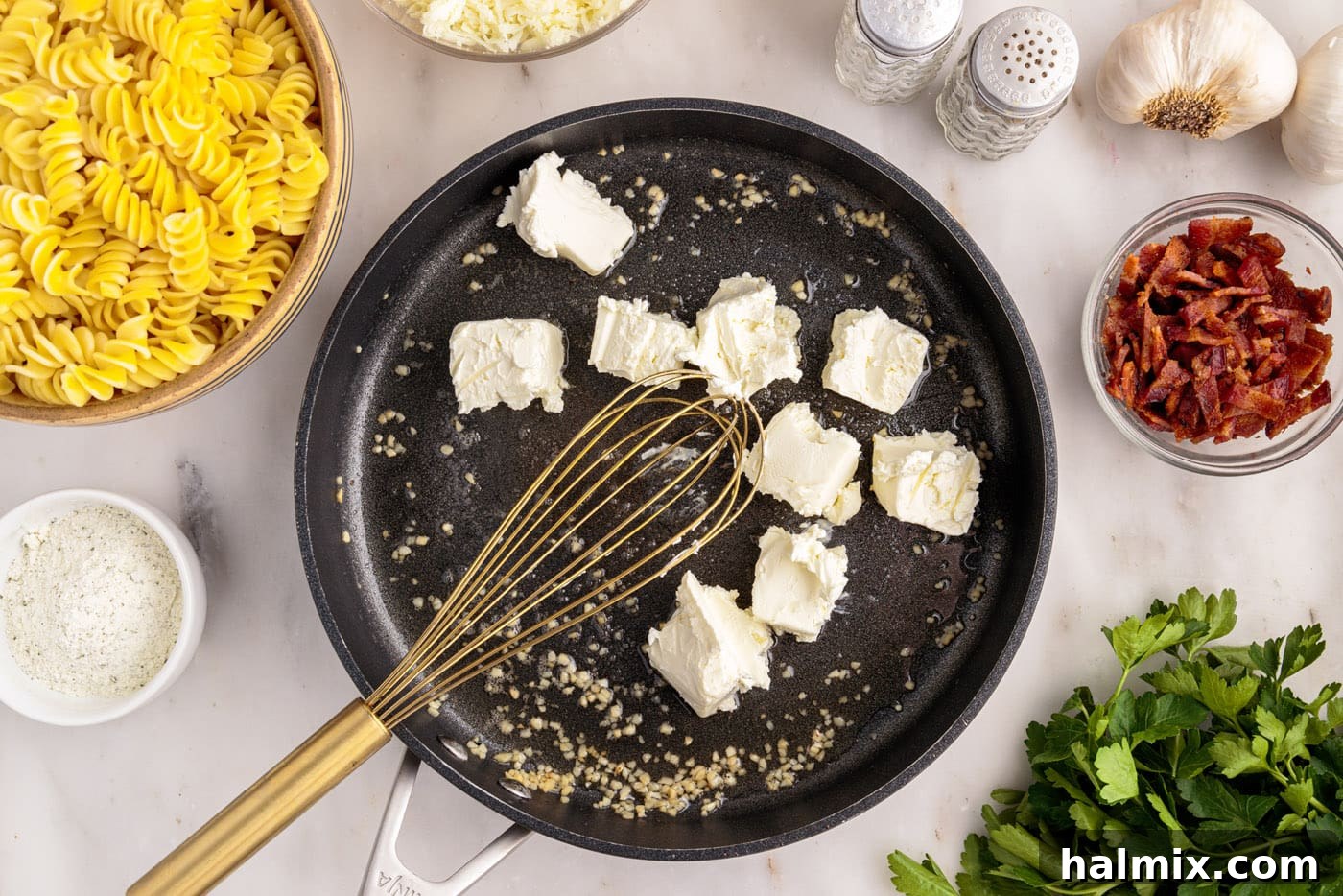 whisking cream cheese into skillet with garlic