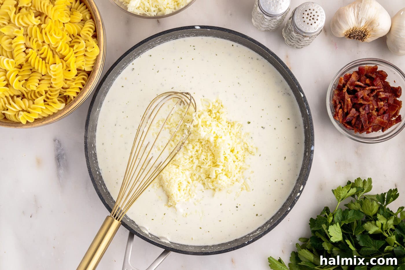 whisking cheese into cream cheese mixture in a skillet
