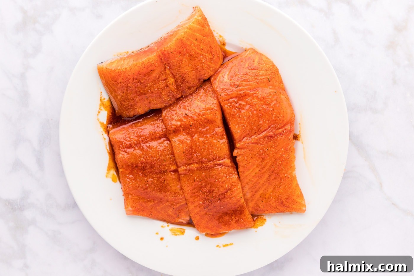 Succulent Roasted Salmon 6 Salmon filets coated evenly in a wet rub of olive oil, garlic salt, and paprika