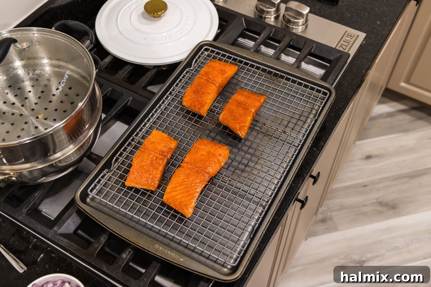 Succulent Roasted Salmon 7 Four seasoned salmon filets arranged skin-side down on a wire rack over a baking sheet