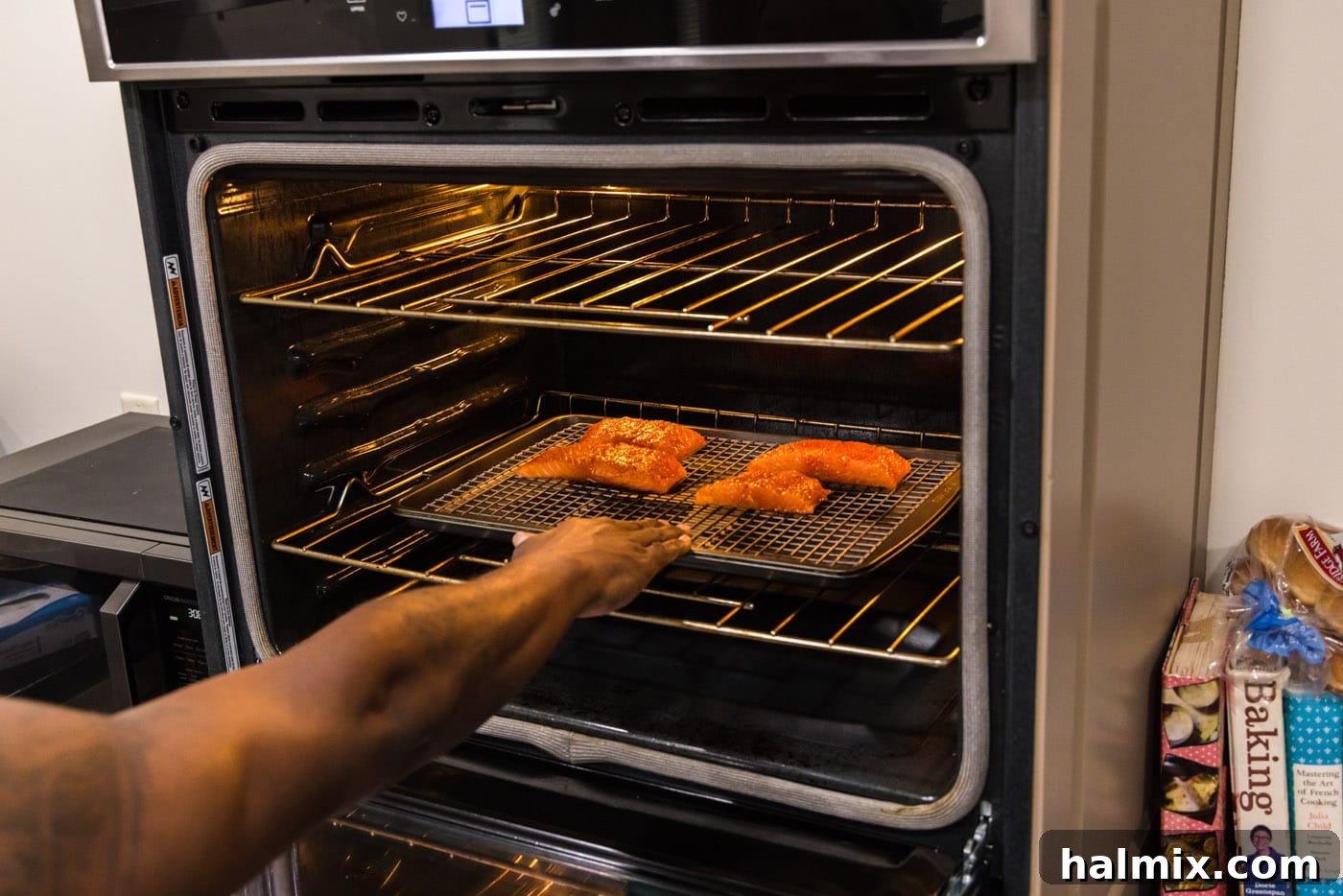 Succulent Roasted Salmon 8 A baking sheet with salmon fillets being placed into a hot oven to roast