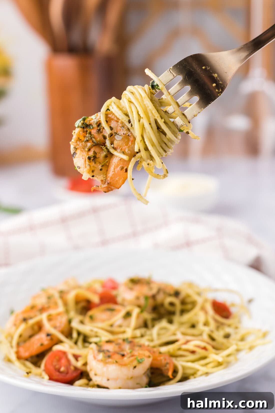 Shrimp Pesto Pasta being picked up with a fork, showing its delicious texture