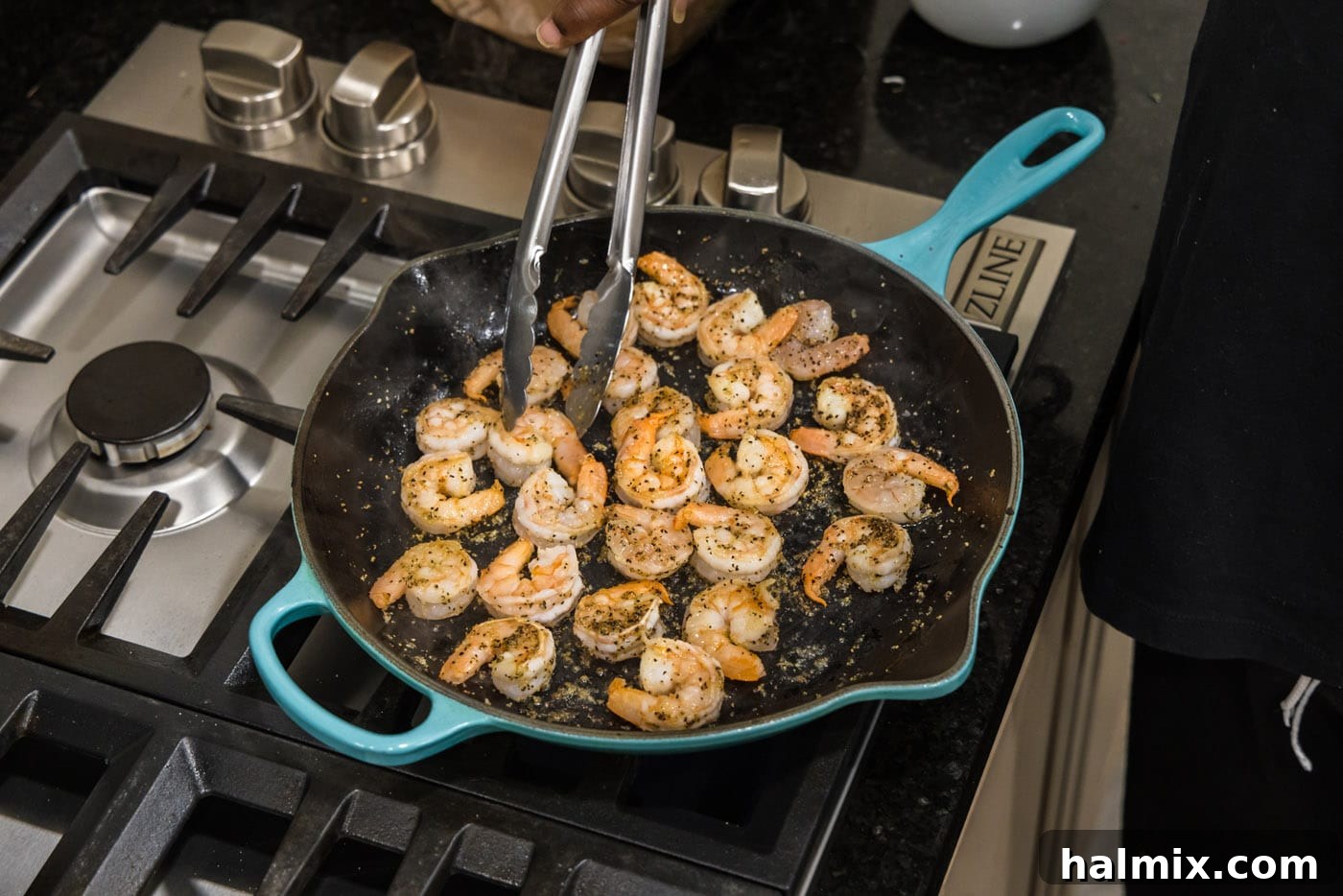 Turning shrimp in a skillet to cook evenly on both sides