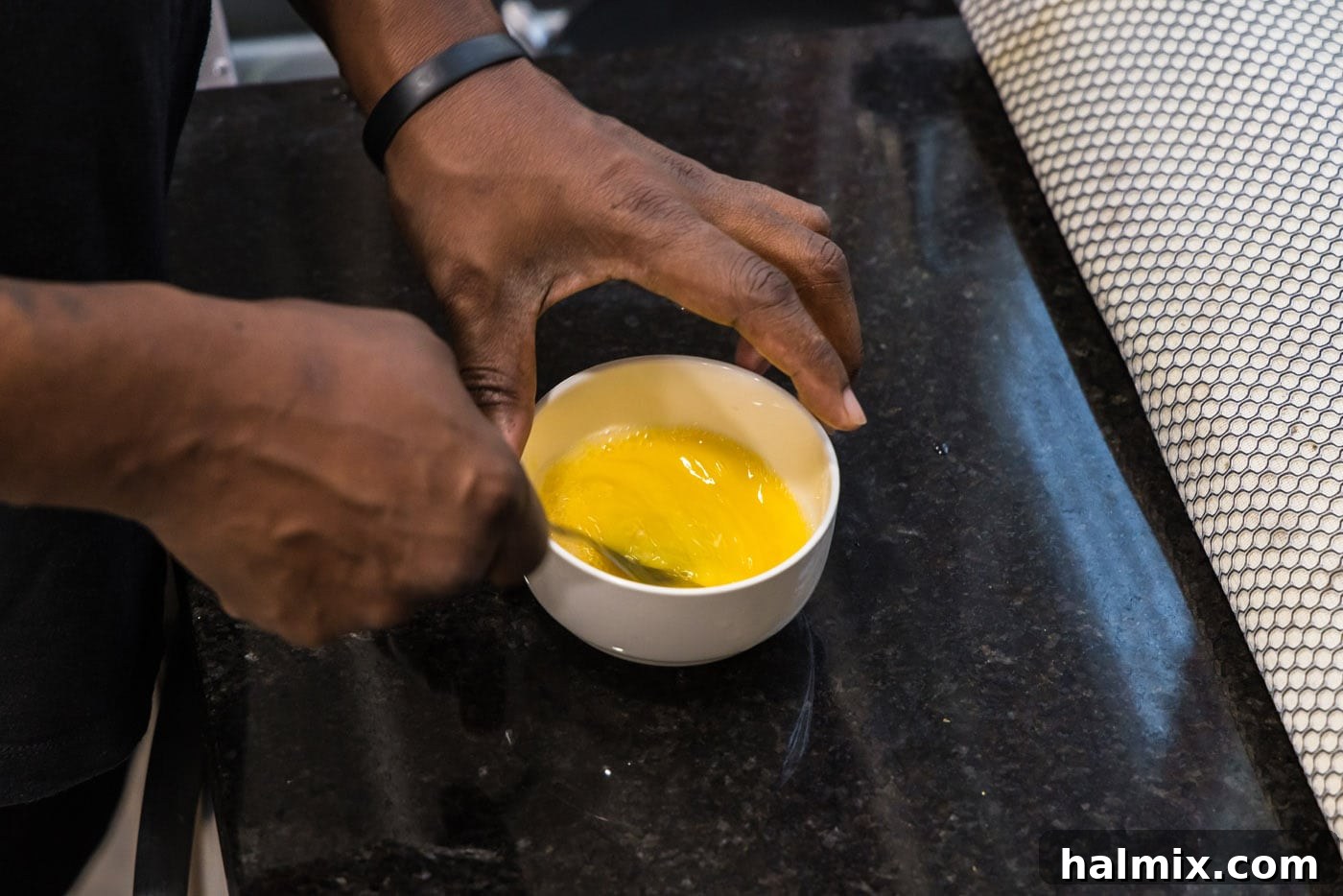 Golden Seared Scallops 6 whisking eggs in a bowl