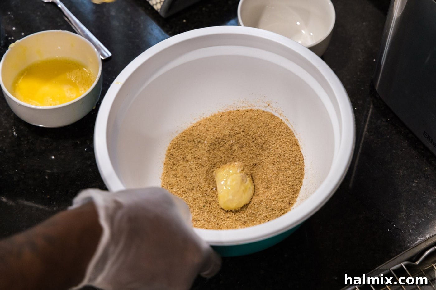 Golden Seared Scallops 9 flour dredged scallop in a bowl of breadcrumbs