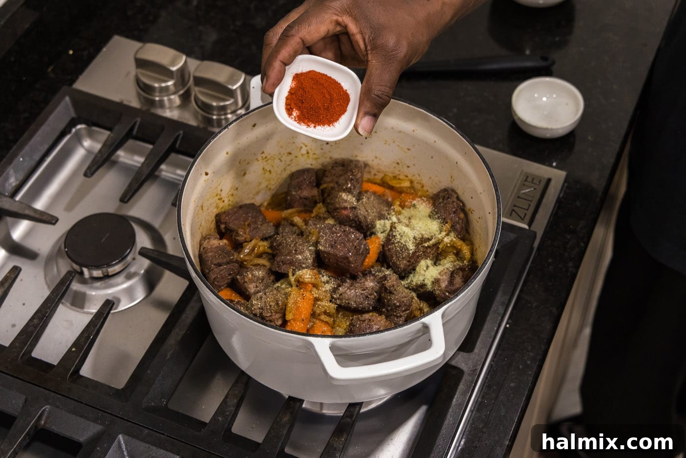 sprinkling paprika on braised beef