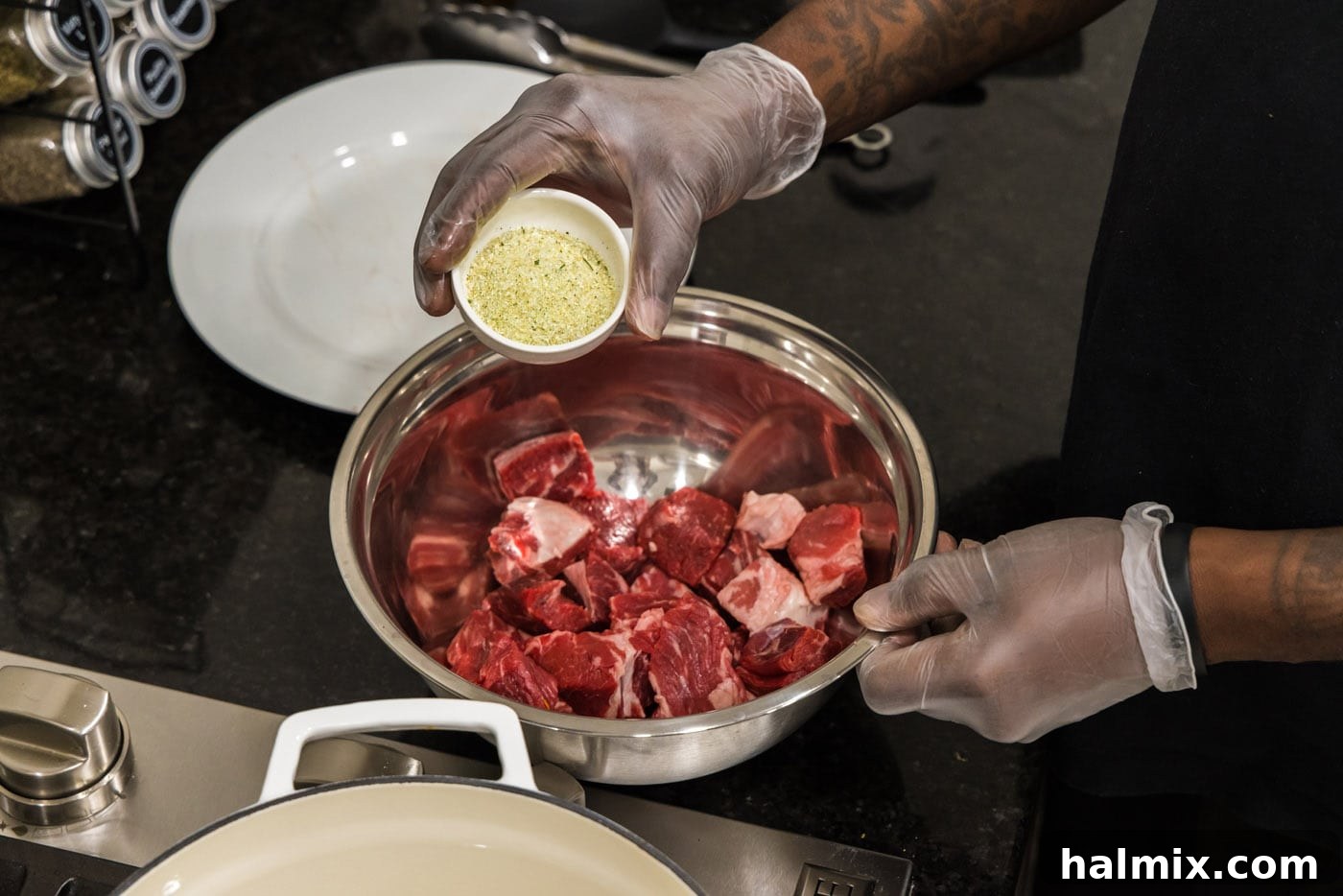 adding garlic salt to cubed chuck roast
