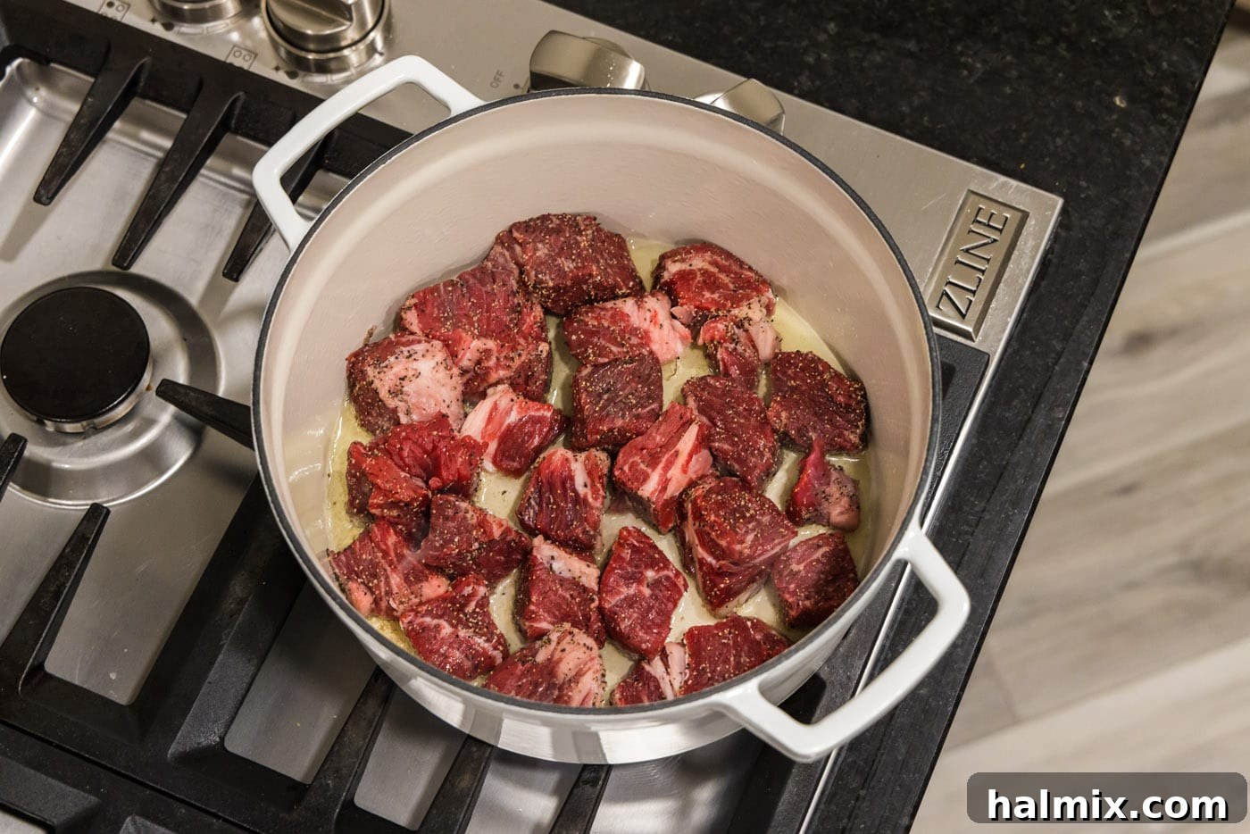 chuck roast cubes in a dutch oven with oil