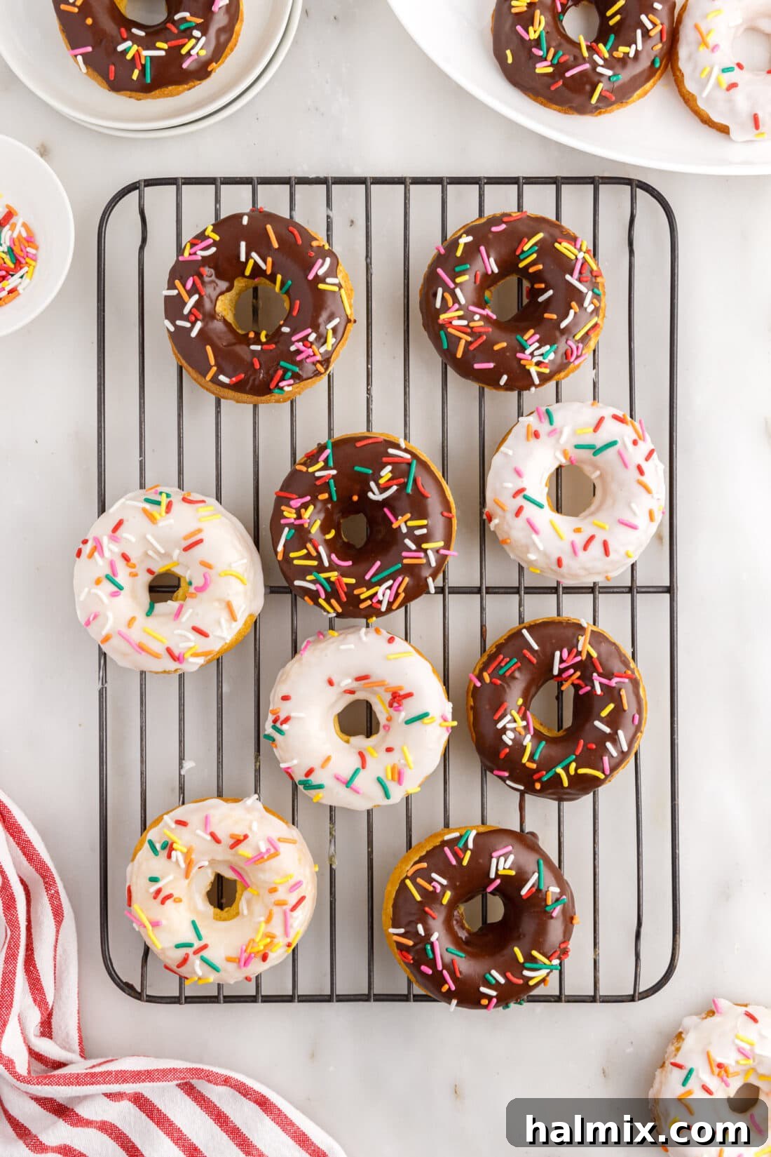Easy Cake Mix Donuts 3 Cake Mix Donuts resting on a wire cooling rack