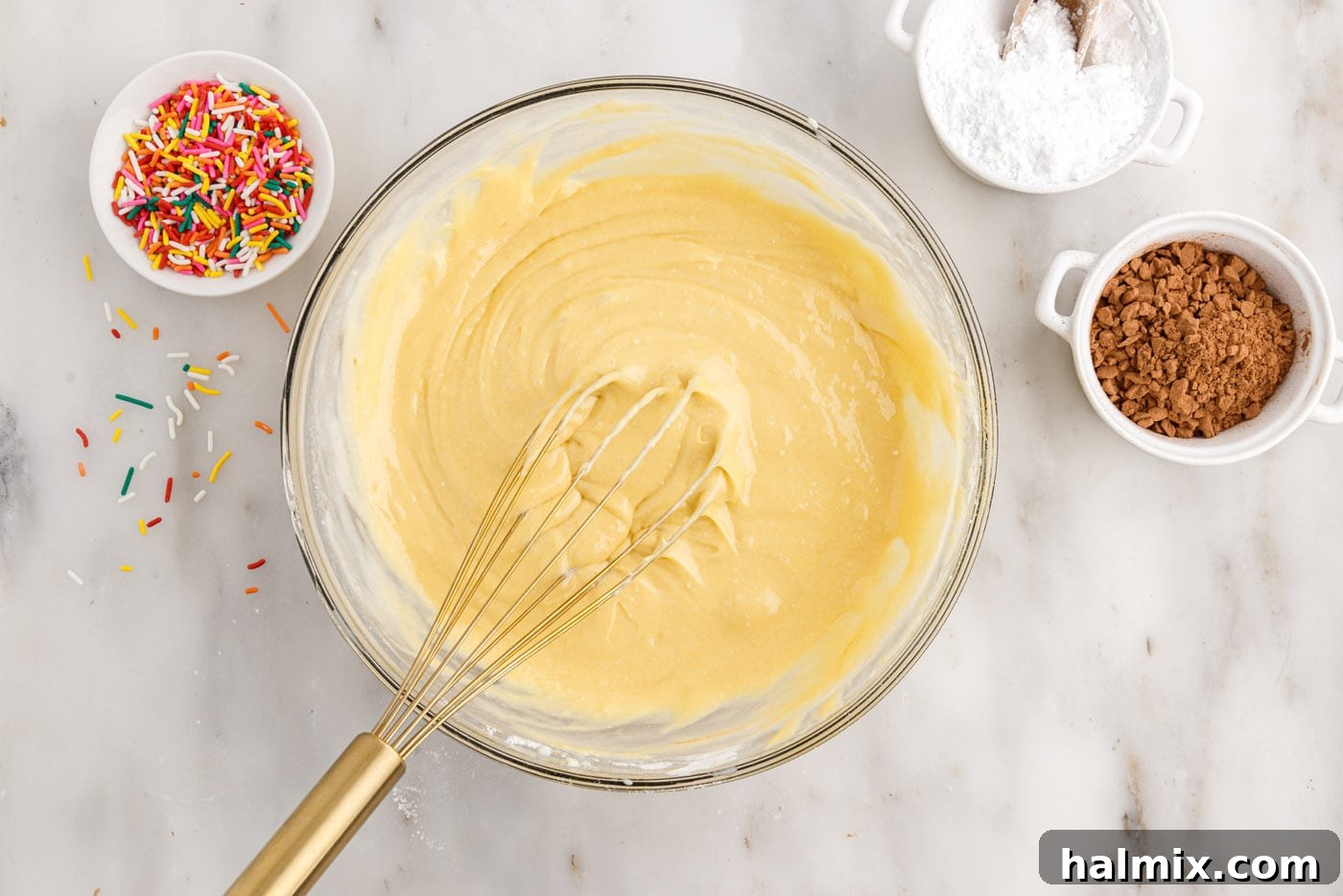 whisking together cake mix with eggs, milk, oil, and sour cream