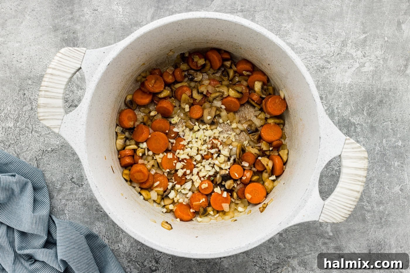 onion, mushrooms, garlic, and carrots in a Dutch oven with butter
