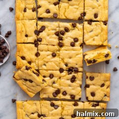 Easy Cake Mix Cookie Bars 14 Cake Mix Cookie Bars on parchment paper with chocolate chips