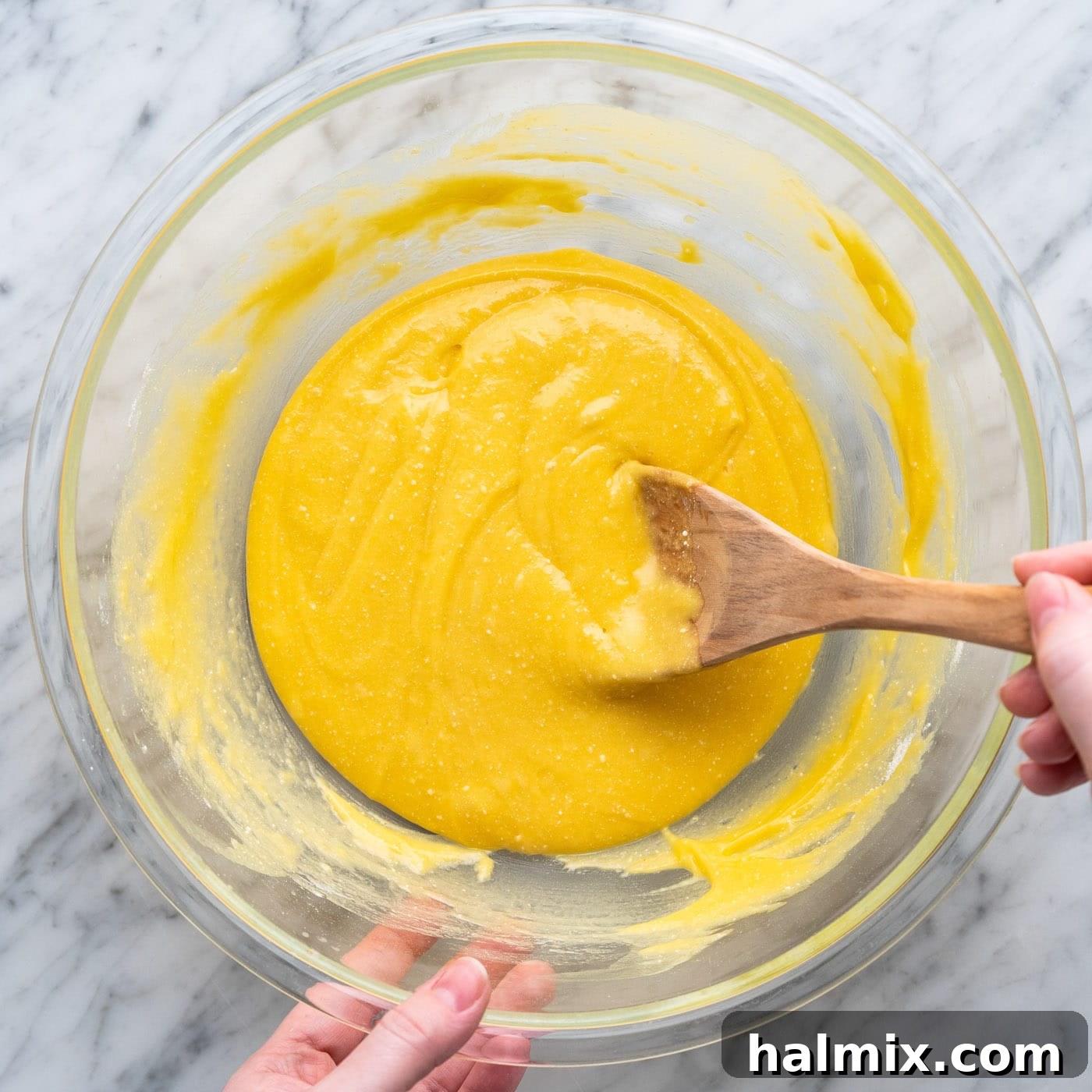 The cake mix batter fully mixed in a bowl, showcasing its thick consistency.