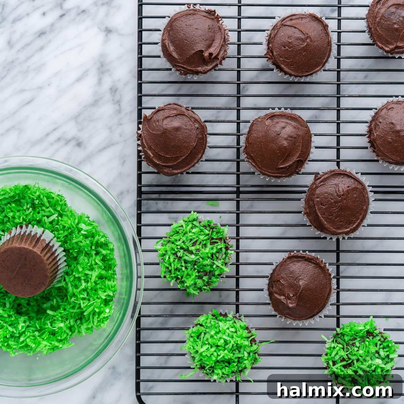 dipping cupcakes into shredded coconut
