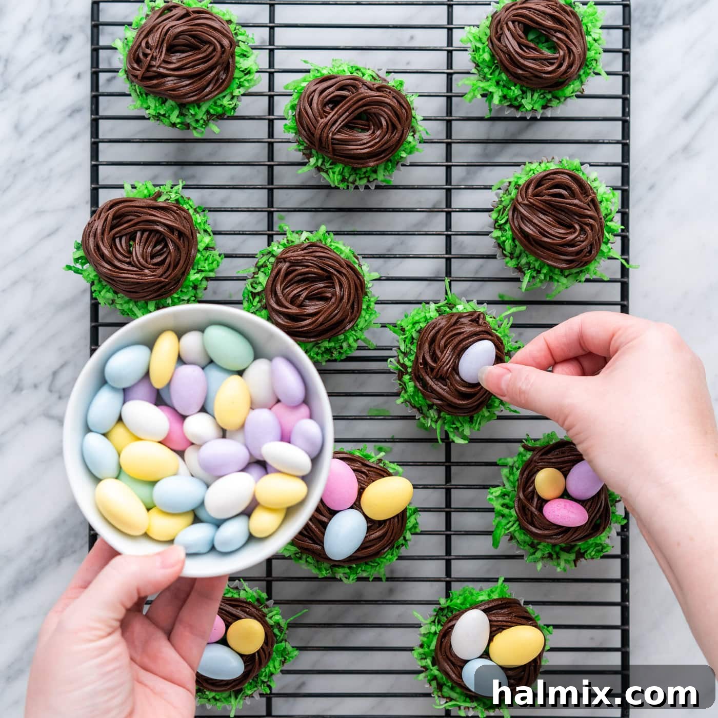 adding chocolate egg candy to easter nest cupcakes