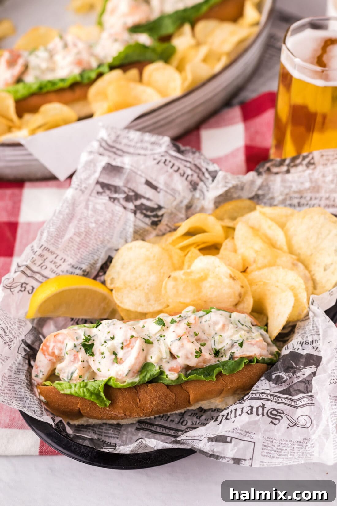 Shrimp Roll In a basket with potato chips and a lemon wedge