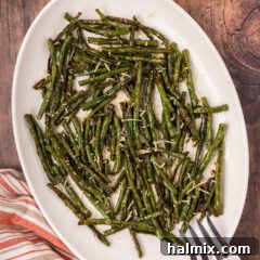 Crispy Roasted Green Beans 6 Roasted Green Beans on a serving platter with a serving fork