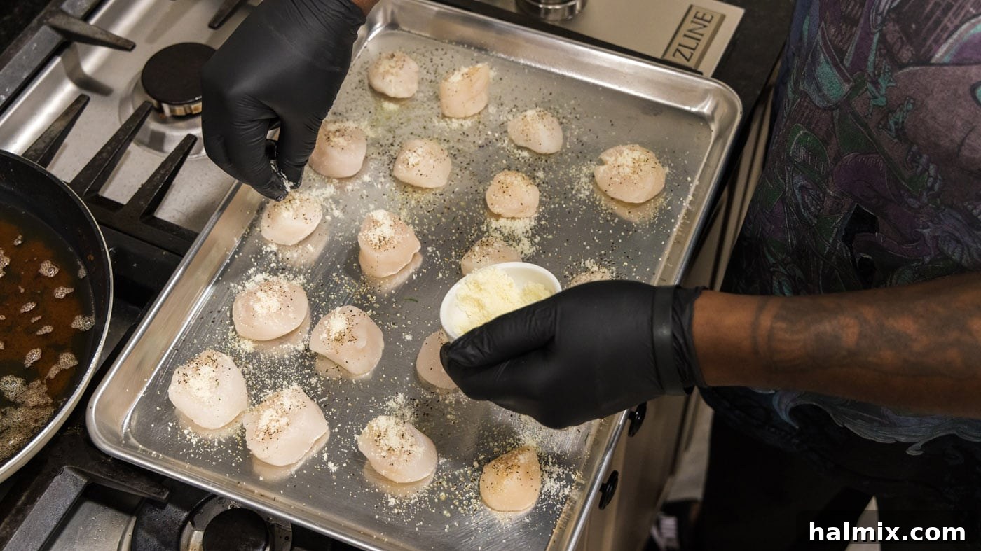 Lemon Garlic Baked Scallops 8 Grated Parmesan cheese being added to the scallops, complementing the breadcrumbs.