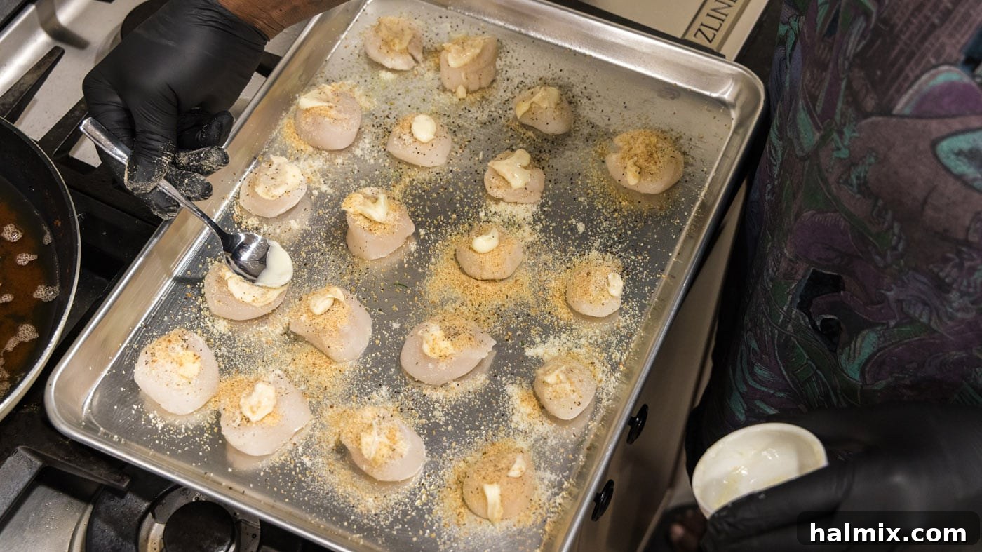 Lemon Garlic Baked Scallops 9 Brushing softened butter over the scallop topping.