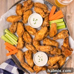 Platter of Fried Chicken Wings with carrots, celery and ranch cups for dipping.