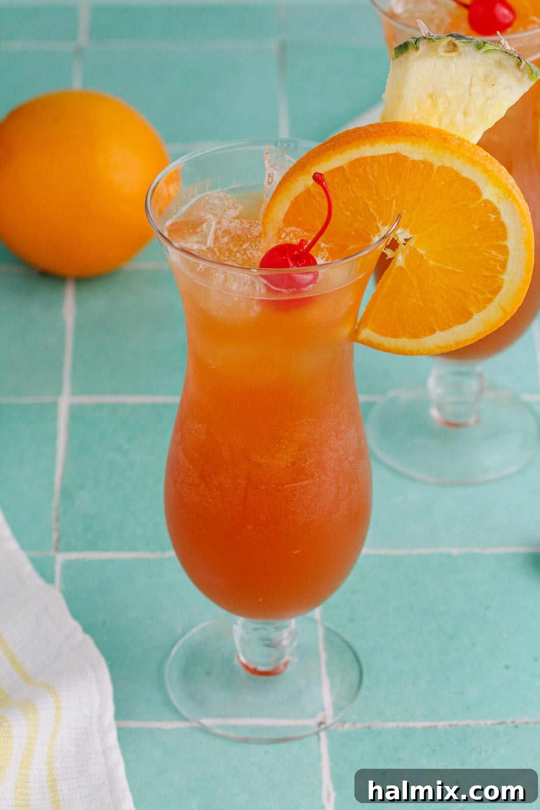 Rum Runner garnished with an orange wheel, pineapple wedge and cherry