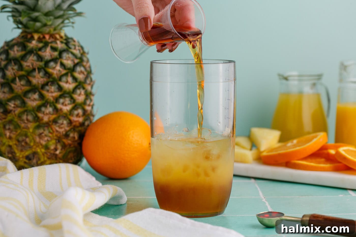 pouring rum into cocktail glass