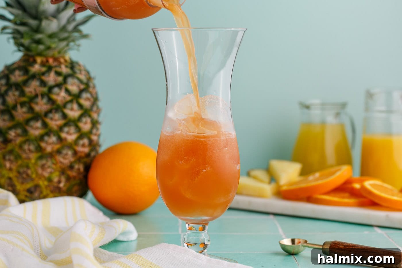 pouring rum runner into a hurricane glass