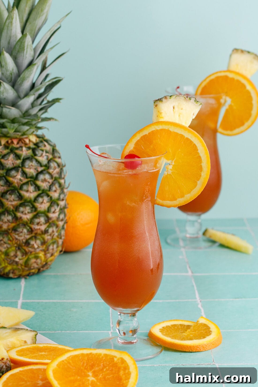 Rum Runner with garnishes and a pineapple in the background