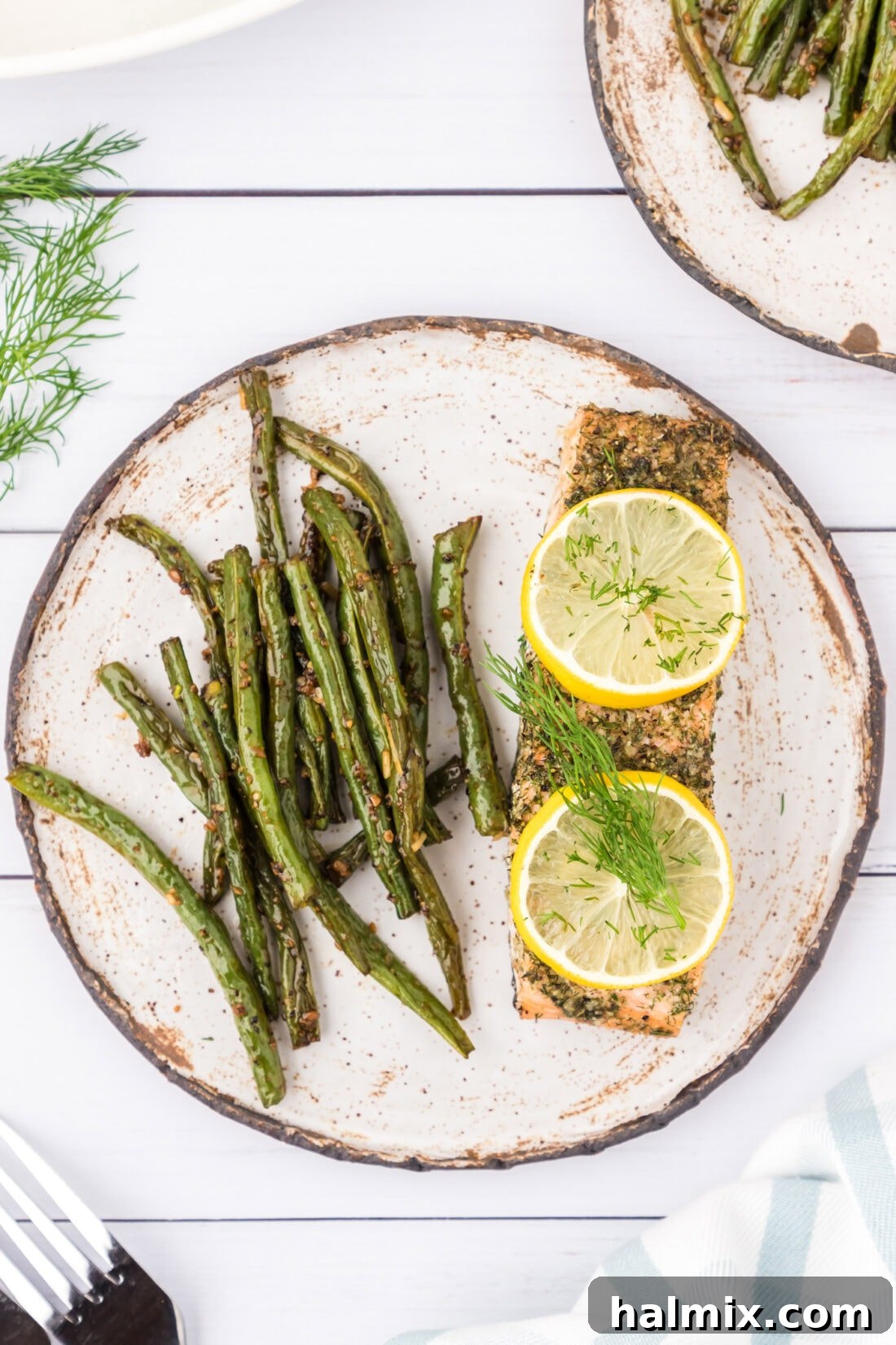 Smoked Salmon with Dill 11 A delicious serving of baked Dill Salmon on a white plate, accompanied by vibrant green beans, ready for a healthy and satisfying meal.
