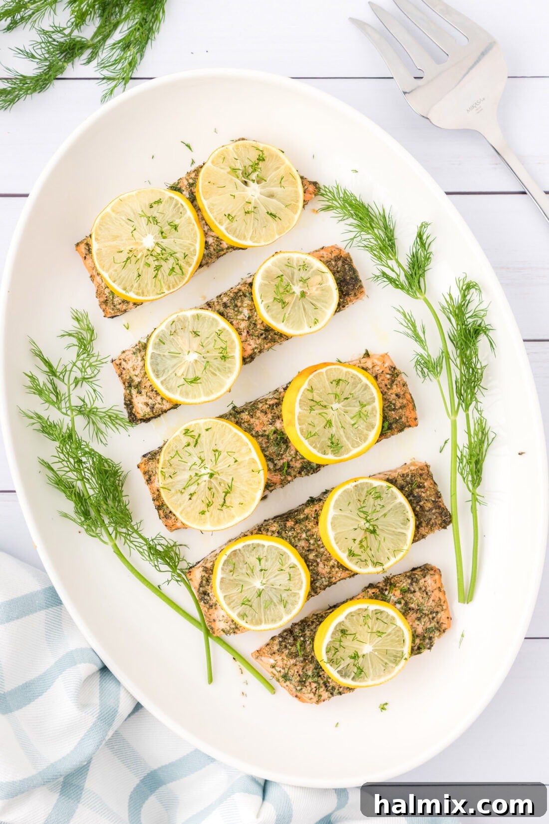 Smoked Salmon with Dill 3 A vibrant platter of freshly baked Dill Salmon, garnished with lemon slices and sprigs of fresh dill, ready to be served.