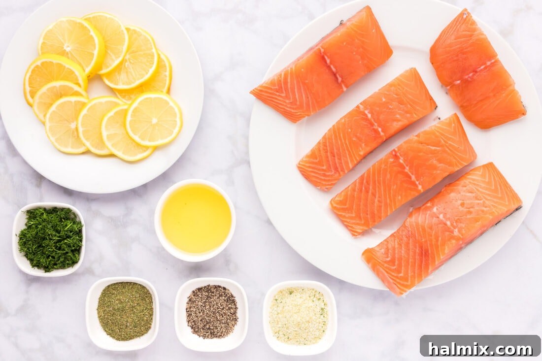 Smoked Salmon with Dill 4 An overhead shot showcasing the fresh ingredients for dill salmon: salmon fillets, lemons, fresh dill, dried dill, olive oil, garlic salt, and black pepper.