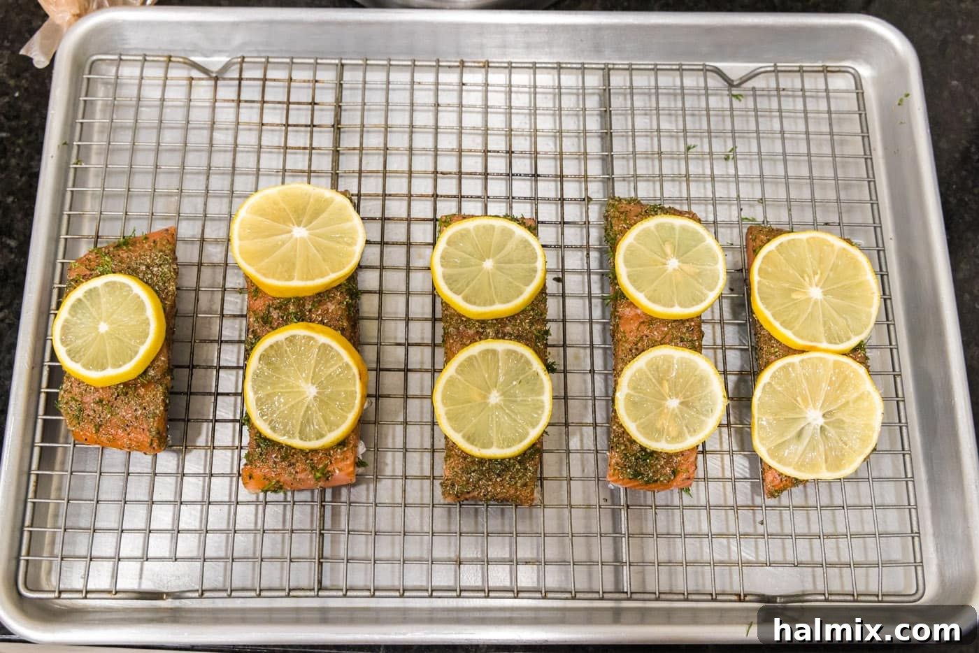 Smoked Salmon with Dill 8 Thin lemon slices carefully placed on top of each dill-seasoned salmon fillet on the baking sheet.