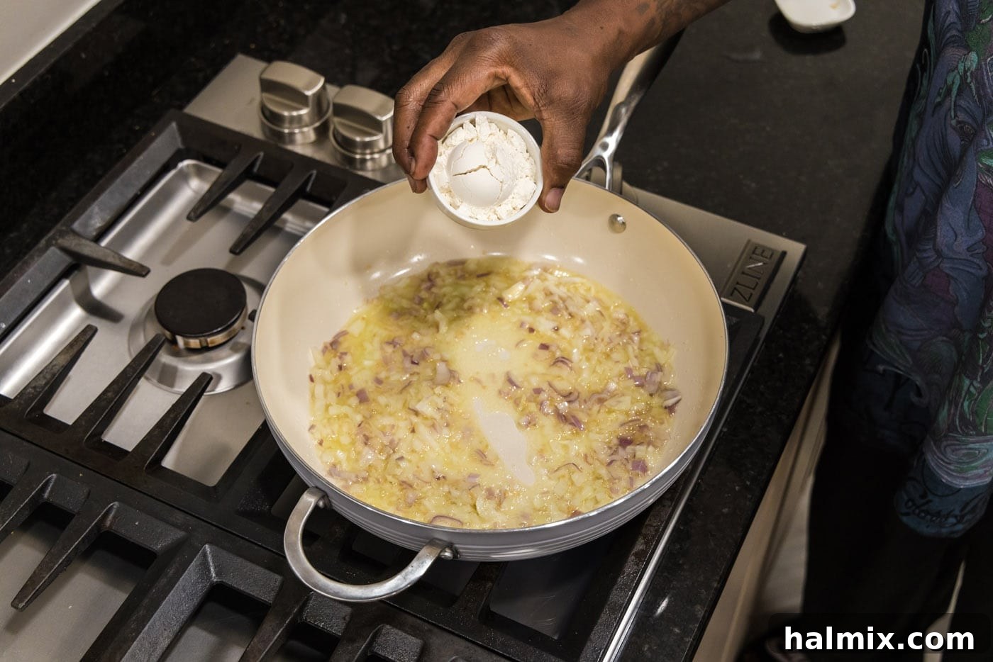 adding flour to skillet to make a roux