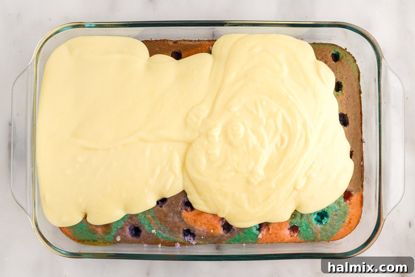 vanilla pudding on top of poke cake