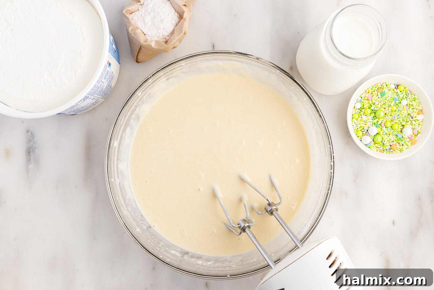 using a hand mixer to beat cake batter