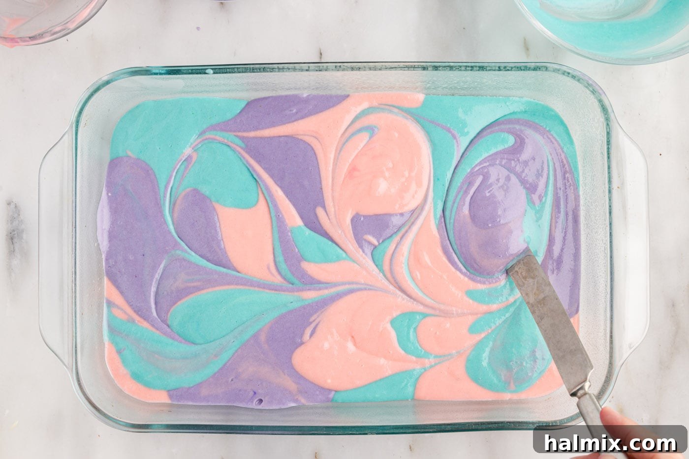 gently swirling colorful cake batter together