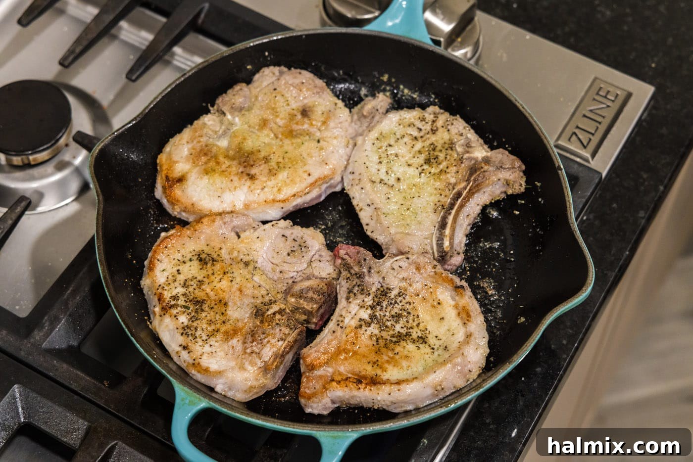 seared pork chops in a skillet