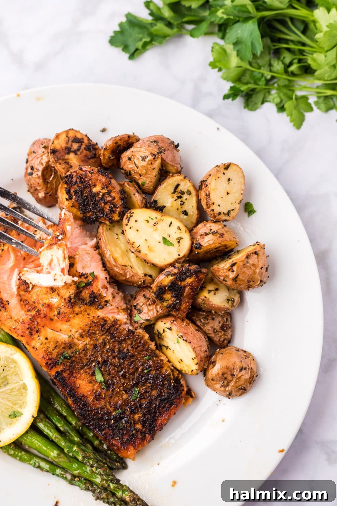Roasted Red Potatoes on a plate with broiled salmon and asparagus