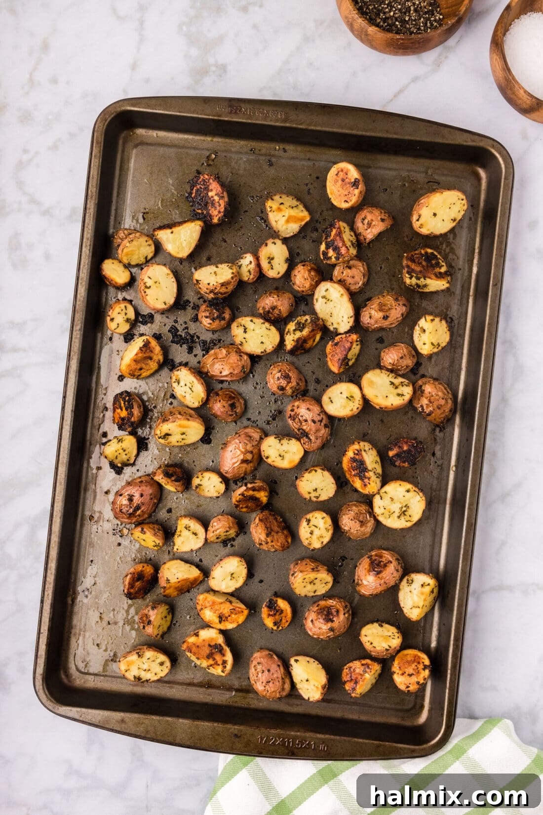 Roasted Red Potatoes fresh out of the oven on a sheet pan, golden and steaming