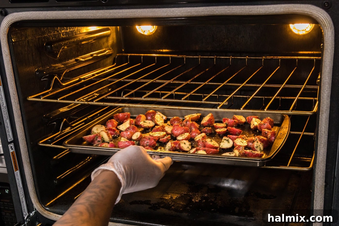 red potatoes on a baking sheet in the oven, starting to brown