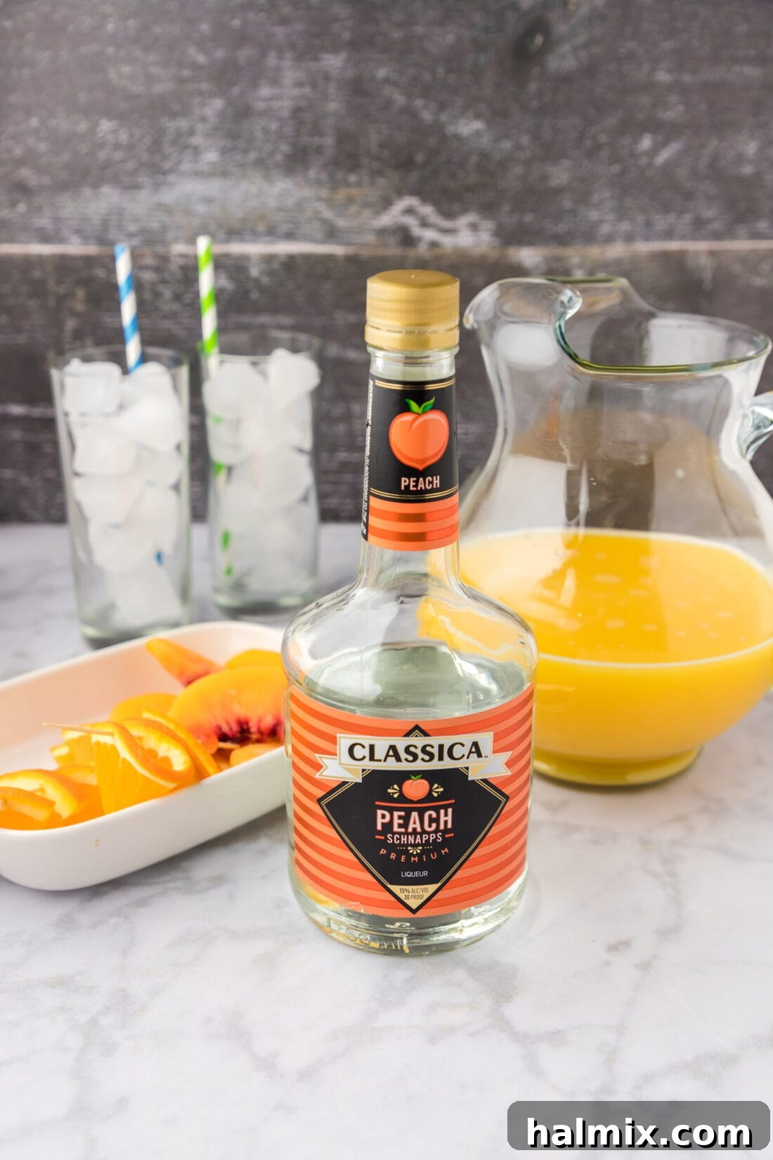 Velvet Peach Sunset 4 Ingredients for Fuzzy Navel cocktail laid out on a table
