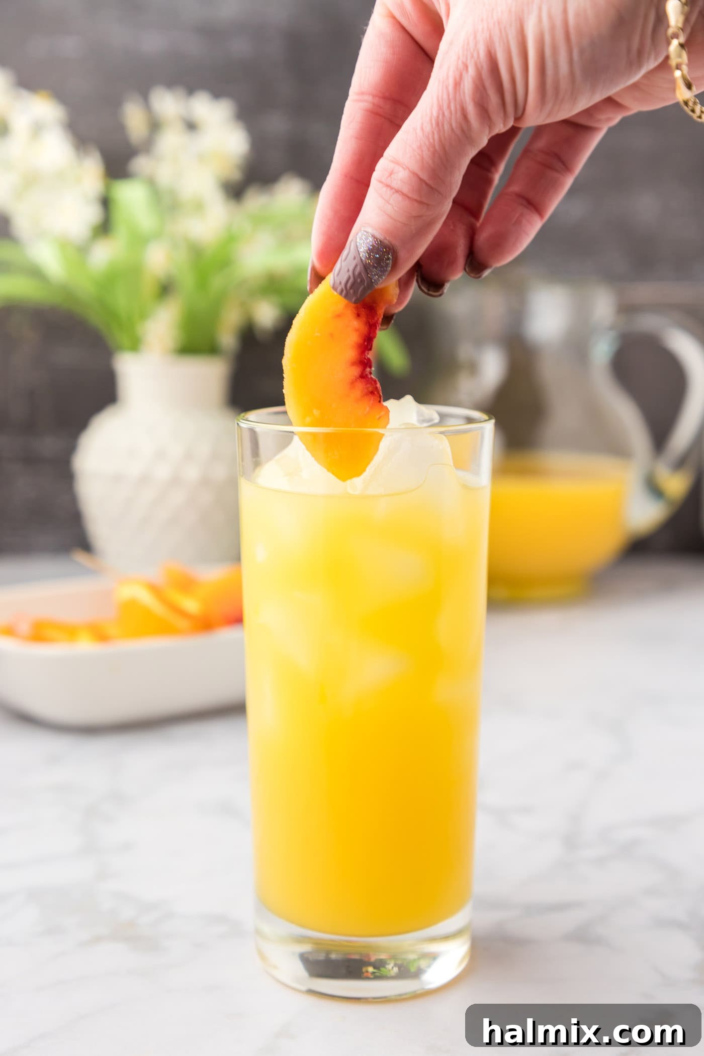 Velvet Peach Sunset 9 Adding frozen peach slices to Fuzzy Navel cocktail