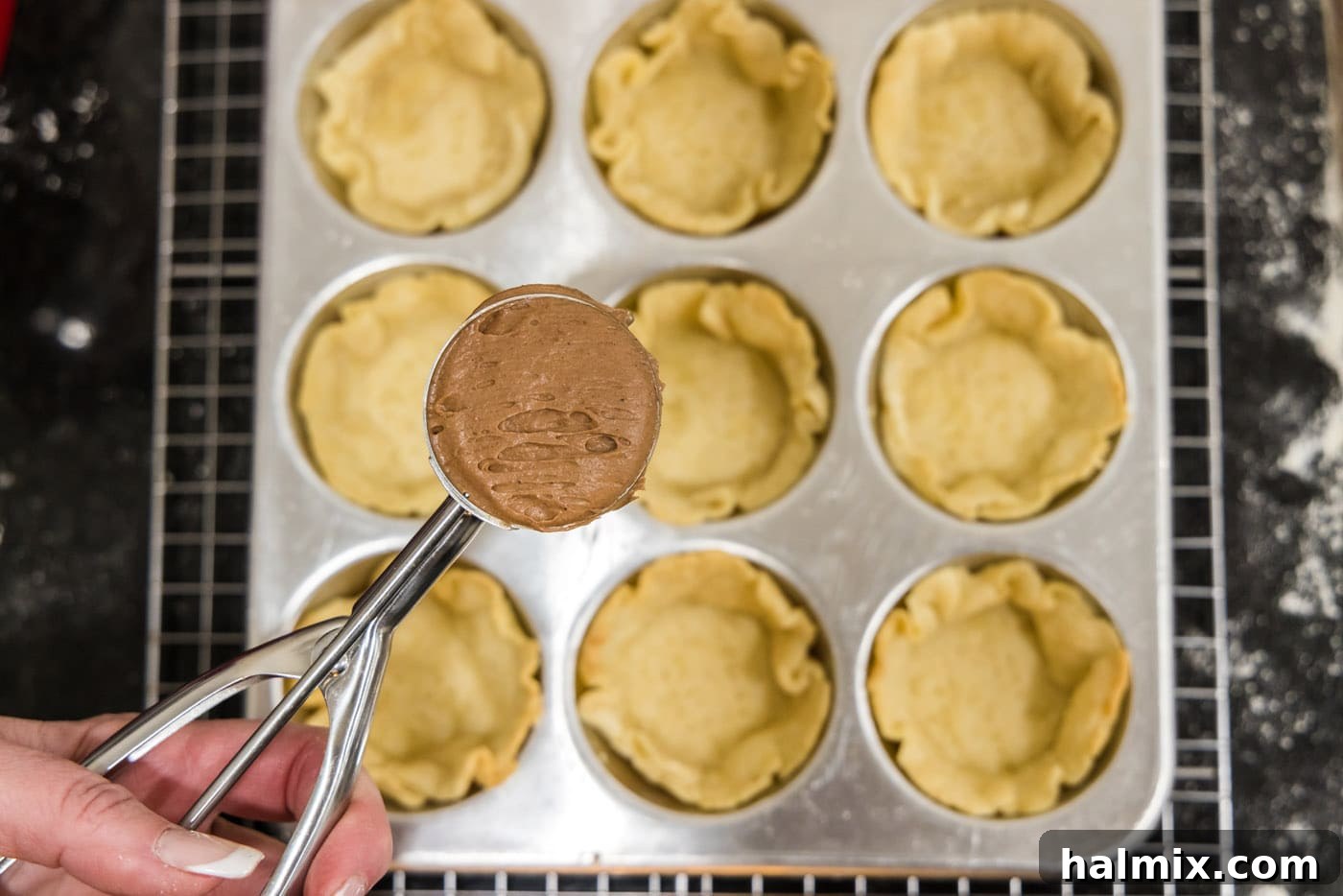 Decadent Mini French Silk Treats 25 scooping french silk filling into mini pie crusts