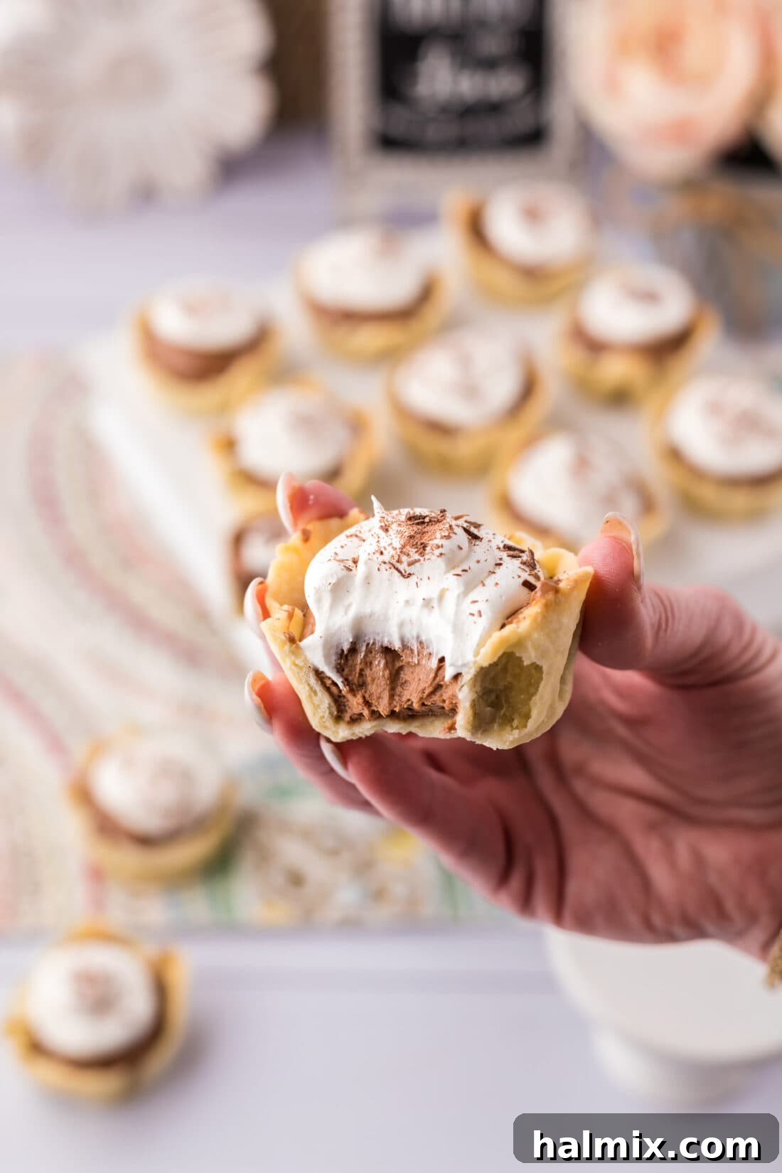 Decadent Mini French Silk Treats 30 Hand holding a Mini French Silk Pie with a bite taken out