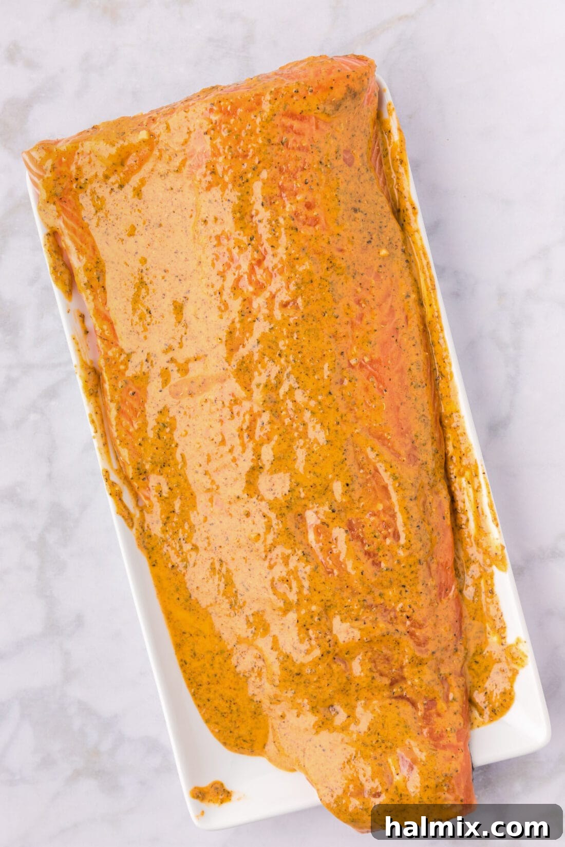 Salmon Marinade spread on salmon on a serving tray