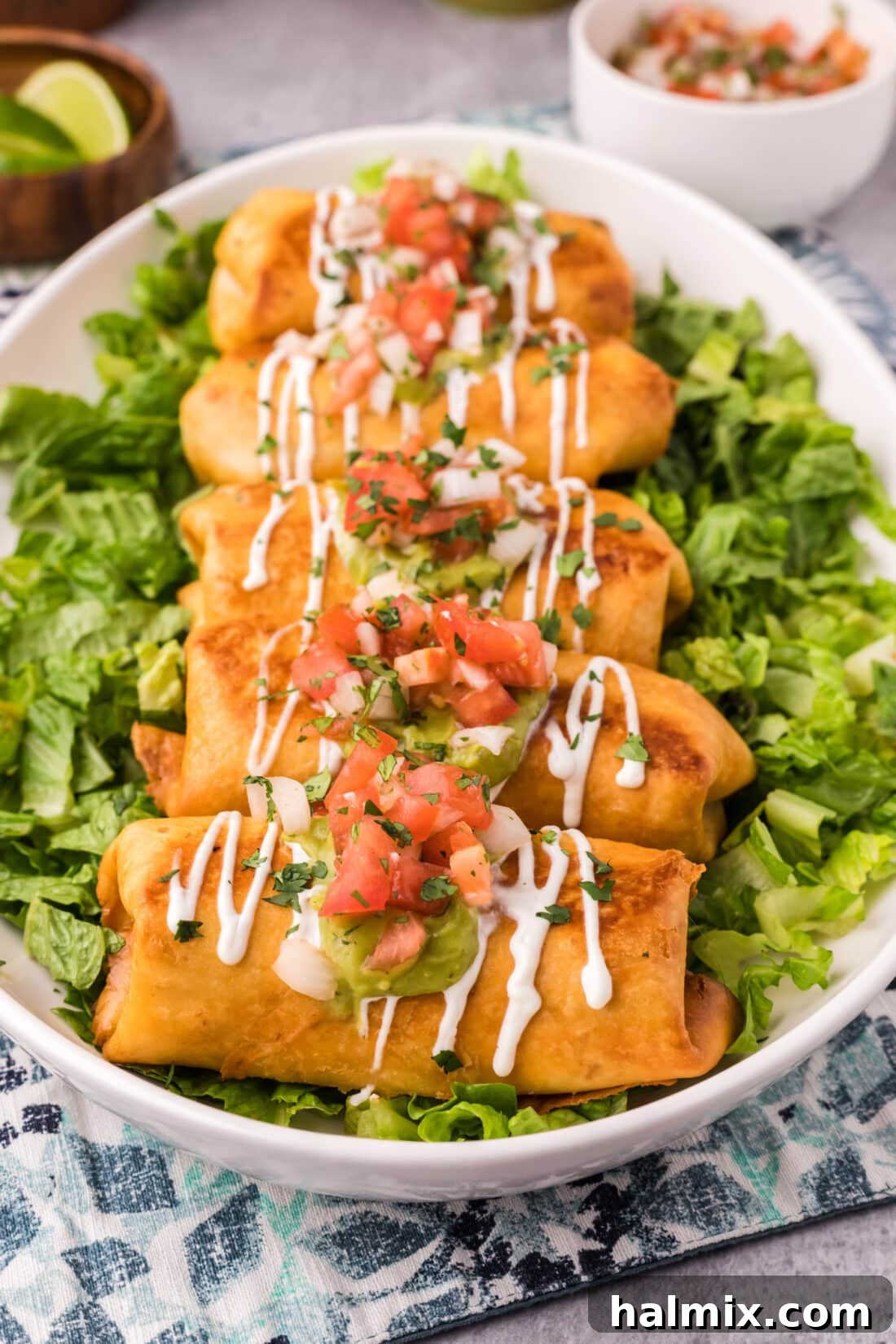 Deep-Fried Mexican Delights 2 Crispy chicken chimichangas served over a bed of fresh lettuce, garnished with lime wedges and a side of salsa