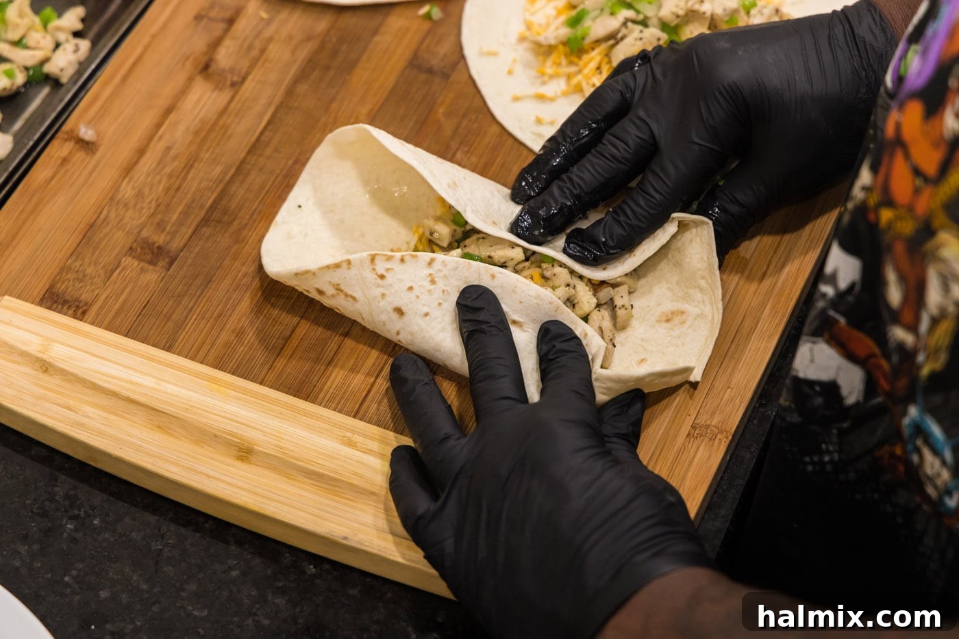 Deep-Fried Mexican Delights 14 hands rolling a chimichanga, demonstrating the technique for a tight wrap