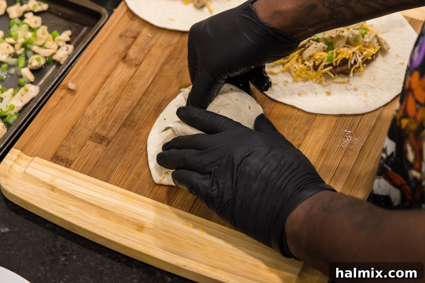 Deep-Fried Mexican Delights 15 folding the sides of a chimichanga, sealing the edges of the tortilla
