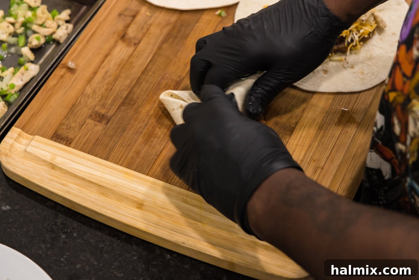 Deep-Fried Mexican Delights 16 rolling a chimichanga tightly, ensuring the filling is secure for frying