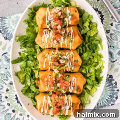 Chimichangas served over a bed of lettuce on a serving platter